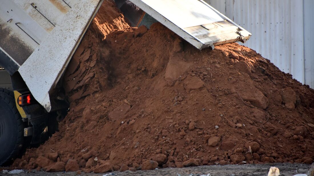 Dump truck unloading soil